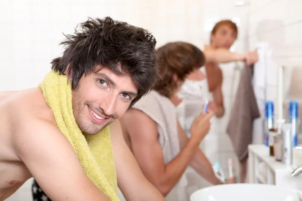 Handsome young man getting ready with his mates — Stock Photo, Image