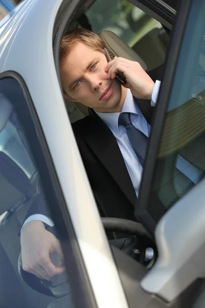 Άνθρωπος χρησιμοποιεί κινητό τηλέφωνο στο αυτοκίνητο — Φωτογραφία Αρχείου
