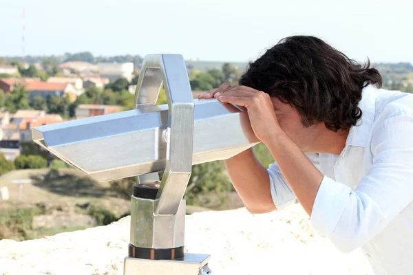 男人透过双筒望远镜看 — 图库照片
