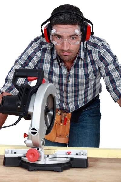 Man with goggles using band-saw — Stock Photo, Image