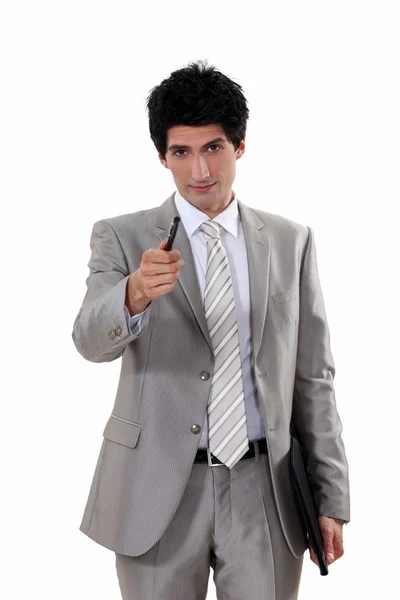 Businessman offering pen — Stock Photo, Image