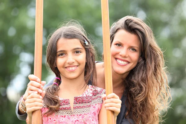 Mother with a daughter on stilts — Stock Photo, Image