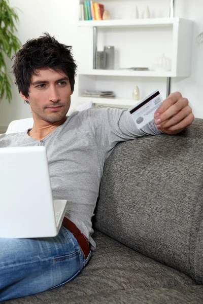 Homme utilisant sa carte de crédit en ligne — Photo