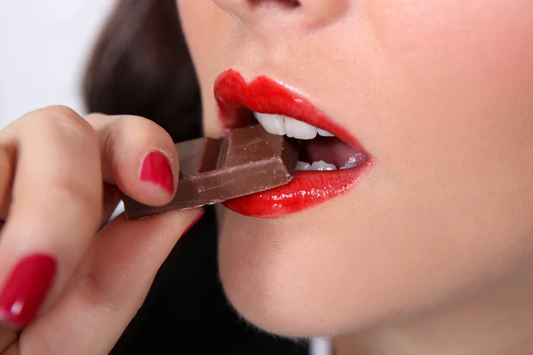Closeup of a woman eating chocolate Royalty Free Stock Images