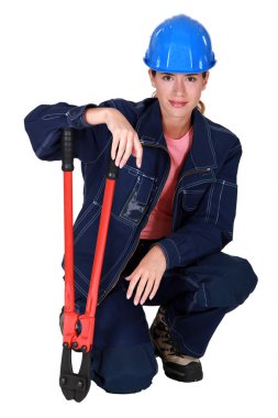 A female construction worker with pliers. clipart