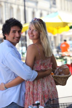 Couple at an open air market clipart