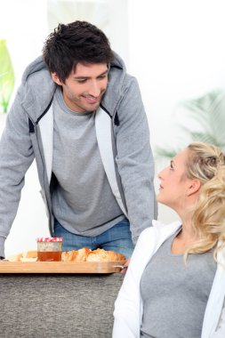 A man bringing breakfast to his wife clipart