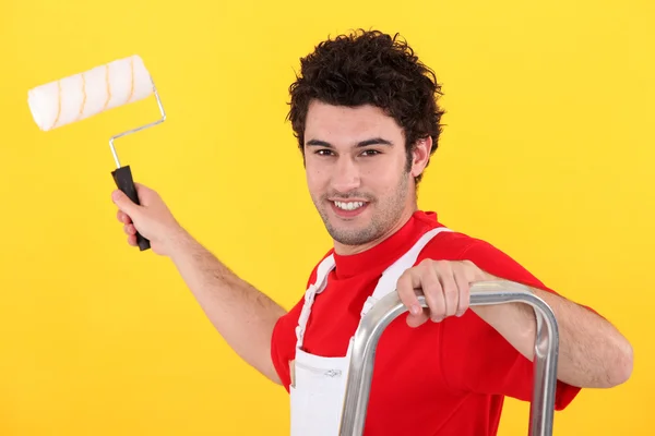 A painter holding a paint roller — Stock Photo, Image