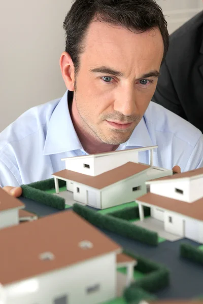 建筑师盯着一个模型 — 图库照片