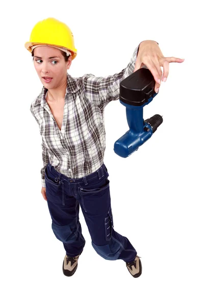 Craftswoman throwing away her drill — Stock Photo, Image