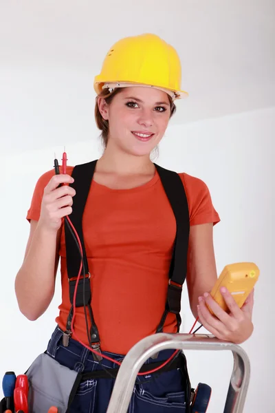 Female electrician using a voltmeter Royalty Free Stock Photos