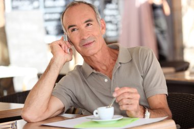 Man on the phone having coffee clipart