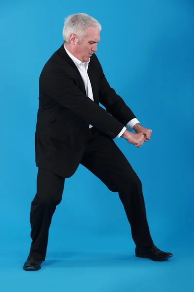 Businessman performing pull gesture — Stock Photo, Image
