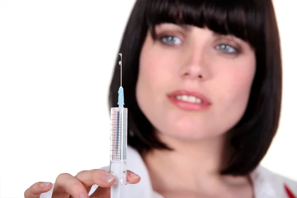 Woman with a hypodermic needle — Stock Photo, Image