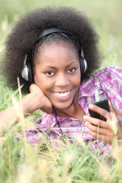 stock image Woman listening to music outside