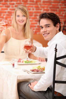 Couple celebrating in restaurant clipart