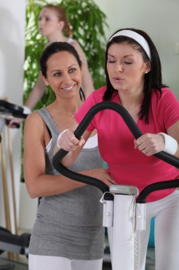 Women working out in a gym clipart