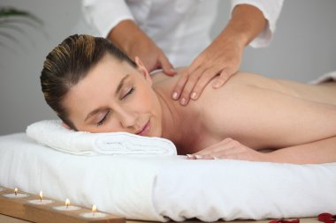 Woman having massage clipart