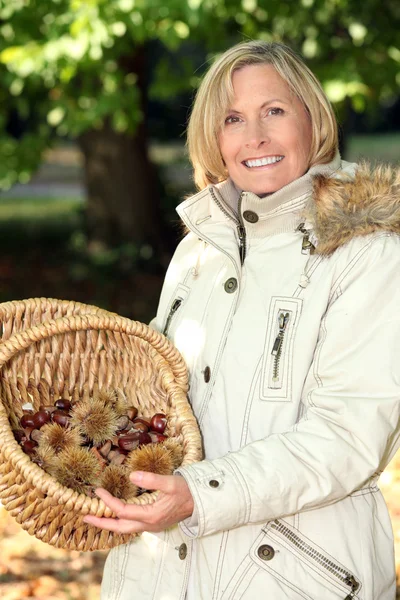 Portrait of a woman with chestnut basket — Stock Photo, Image