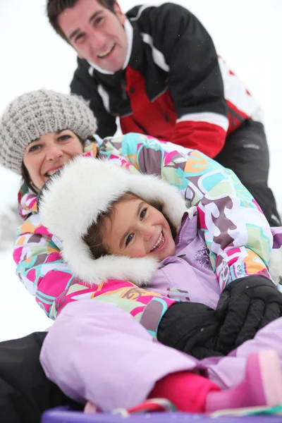 Fiatal család játszani a hóban — Stock Fotó