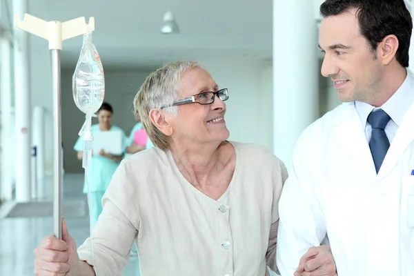 Чоловік лікар допомагає літнім пацієнтам — стокове фото