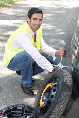 Changing the wheel on a car clipart