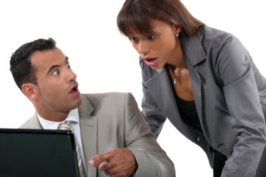 Office workers shocked in front of a computer clipart