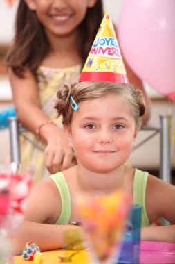 Portrait of a little girl at birthday party clipart