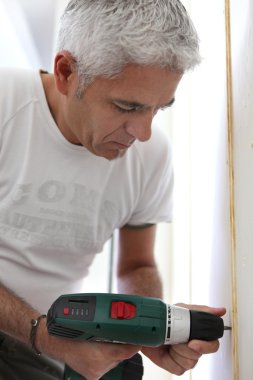 Man using a power tool clipart
