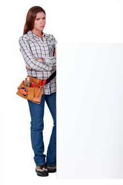 Angry woman standing behind a wall clipart