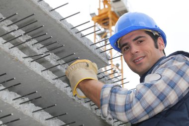 Construction worker with slabs of reinforced concrete clipart