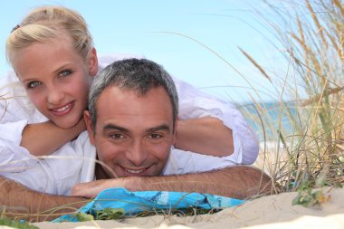 Couple relaxing at the seaside clipart