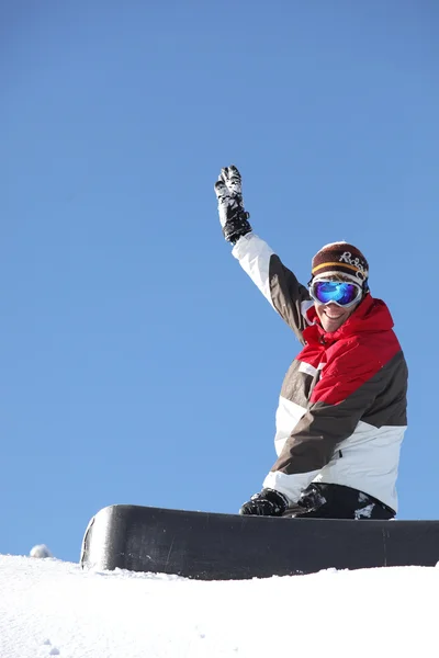 Um snowboarder acenando com o braço — Fotografia de Stock