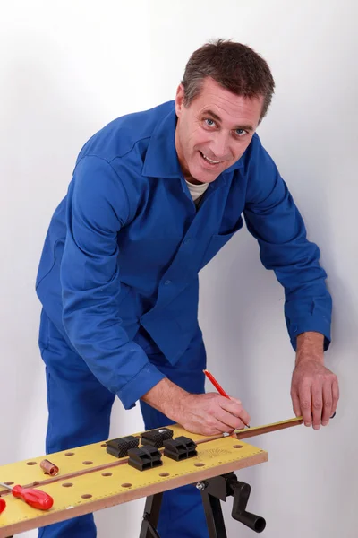 Happy plumber measuring copper pipe — Stock Photo, Image