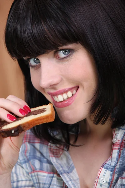 Vrouw eten een segment van marmeren cake — Stockfoto