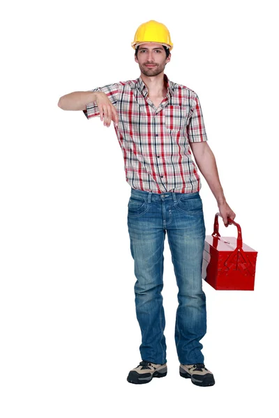 A construction worker carrying a toolbox. — Stock Photo, Image