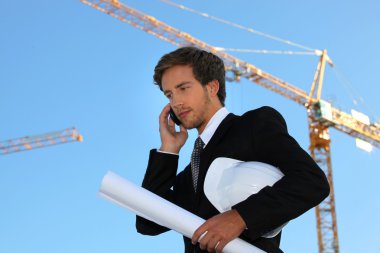 Young and handsome engineer working on-site clipart