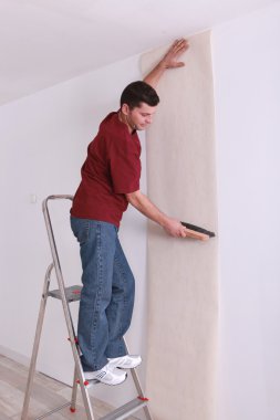 Man upholstering a wall clipart