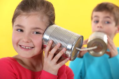 Kids using tin cans to communicate clipart