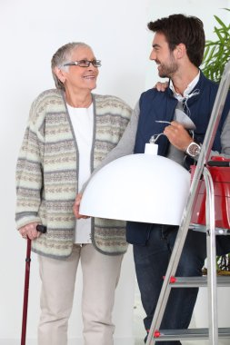 Young man helping older woman clipart