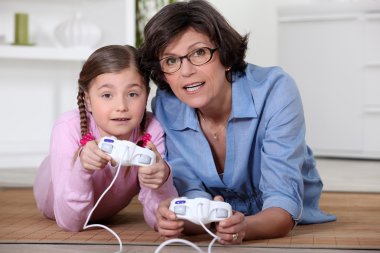 Mother and daughter playing video games clipart