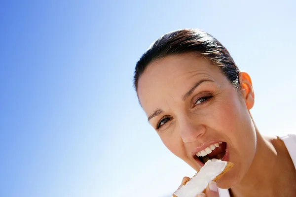 Woman eating a rusk with butter — Stock Photo, Image