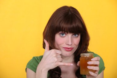 Woman with a pot of honey clipart