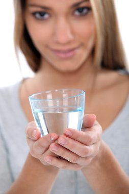 Woman holding glass of water clipart