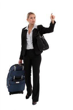 Woman with luggage hailing taxi clipart