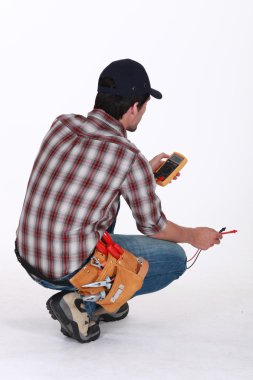 Electrician taking electrical reading clipart