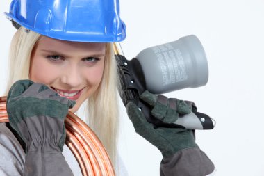 Blond woman with blowtorch and copper pipe clipart