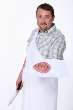 A butcher displaying a coil of sausage clipart