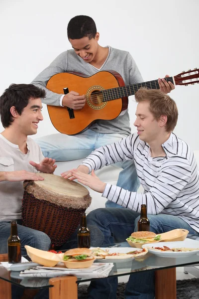 Three friends playing musical instruments