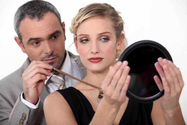 Make-up artist with model — Stock Photo, Image